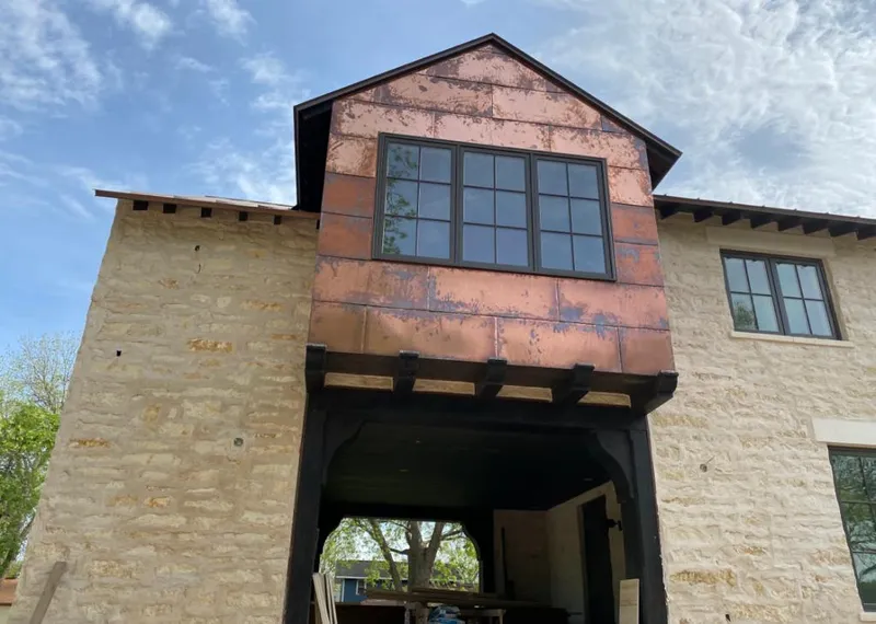 Copper metal panel facade on a stone building for Roof Repair in Altamonte Springs